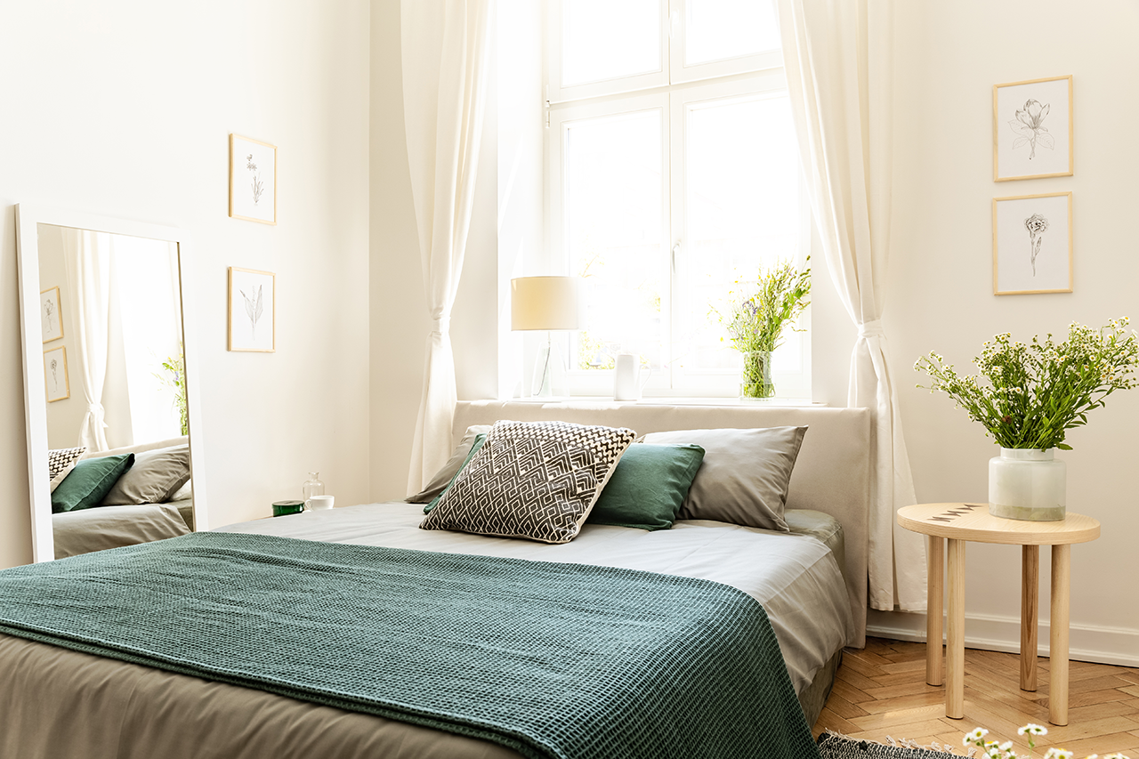 Eco cotton linen and blanket on a bed in nature loving family guesthouse for spring and summer vacation.